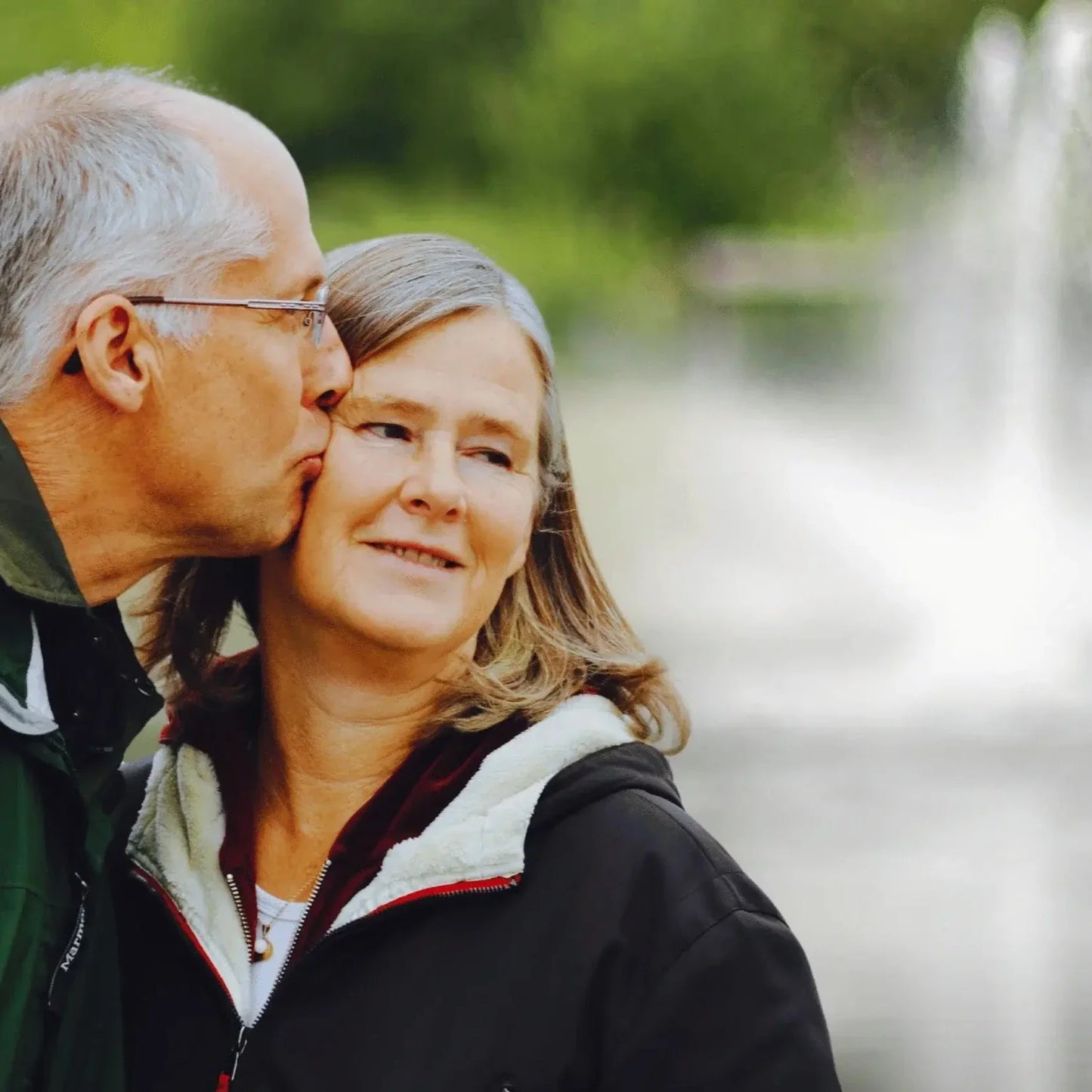 Couple Sitting In Front Of Scott Aerator Pond Fountain